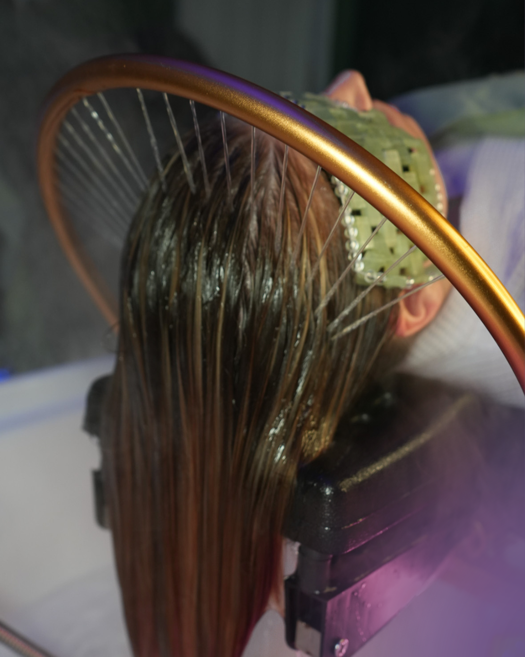 Solari Head Spa guest relaxing under the halo/waterfall with a Bead Mask on her eyes.