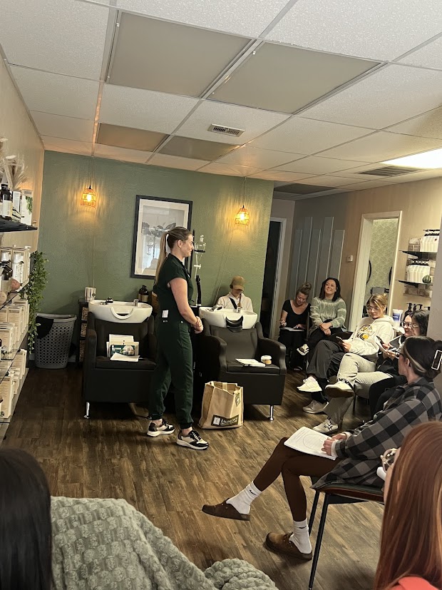 Solari Professionals setting in the salon listening to the Eminenece Organic Skincare educator teach about skincare.